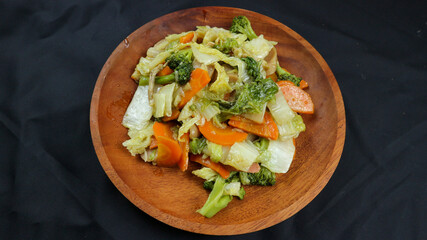 Fried capcay or cap cai or Hokkien is a mixture of vegetables stir-fried with chicken & other dishes. Isolated on black background.