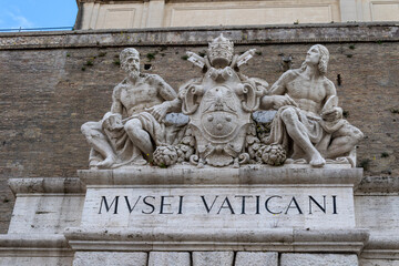 Fototapeta na wymiar Vatican museum insignia at St. Peter's, Rome. Entrance to the pope's museums in the Vatican state.