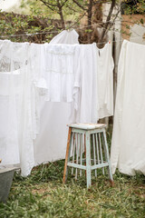 laundry day, clean laundry is dried on ropes in the backyard of a country house, retro style