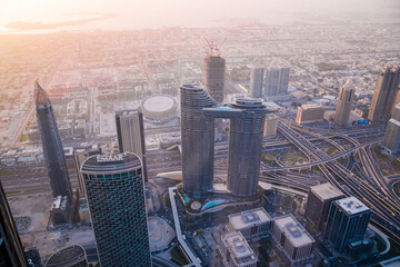Plakat Dubai, UAE. Dubai city at sunsett, view with lit up skyscrapers and roads.