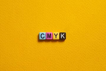 CMYK - word concept on cubes, text
