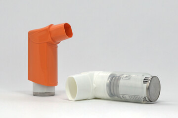 Two asthma inhalers on a white background