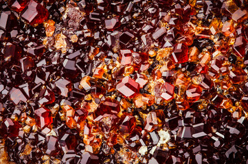 grossular (red garnet) cluster. macro detail texture background. close-up raw rough unpolished semi-precious gemstone