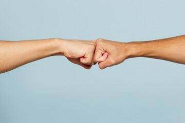 Close up shot of couple two male friends men together hold hands folded fist bump gesture isolated...