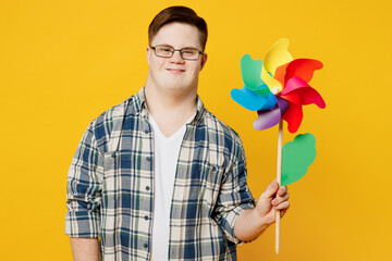 Young smiling cheerful fun man with down syndrome wear glasses casual clothes look camera hold in...