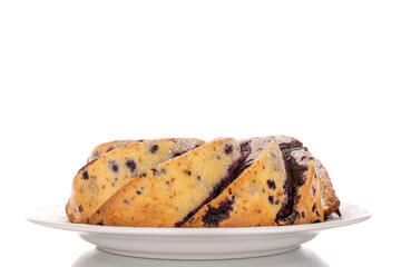 One vanilla cupcake with cherry on white ceramic plate, macro, isolated on white background.