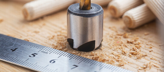 Countersink drill bit with steel triangle ruler make sink in hole for screw in wooden oak plank