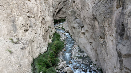 A small and hidden water stream in a narrow gorge of Karakoram mountains, located in Pakistan. 