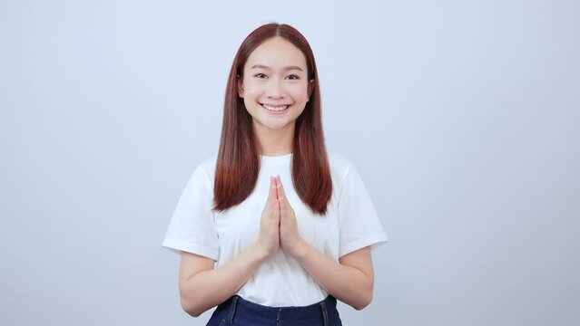 Happy asian girl laughing and smiling expressing gratitude, namaste gesture, thank you.
