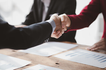 Business investor group handshake, Two businessmen are agreeing on business together and shaking hands after a successful negotiation. Handshaking is a Western greeting or congratulation.