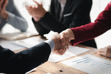 Business investor group handshake, Two businessmen are agreeing on business together and shaking hands after a successful negotiation. Handshaking is a Western greeting or congratulation.