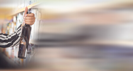 Woman buying vodka at supermarket.