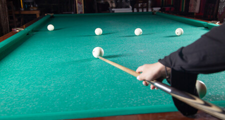 Caucasian young girl playing billiards.