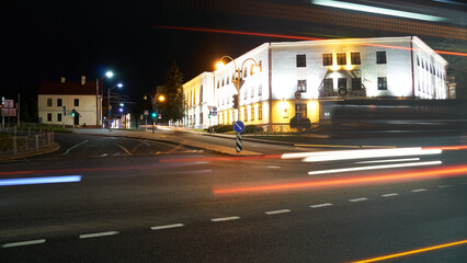 Night city light lines from cars. cars in highway with blur motion. Street view of the modern city at night. A lot of light from car headlights, advertising banners and night lights.