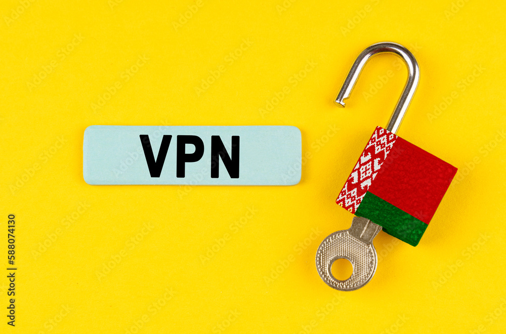Poster on the yellow surface is an open lock with a key and a sticker with the inscription - vpn