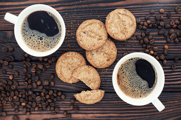Still life. Coffee in a white cup on a wooden table and cookies. Sweet backgrounds