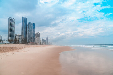 Spectacular panorama of the Gold Coast skyline and Surfers Paradise beach with rolling waves of Pacific ocean on a beautiful cloudy day.	
