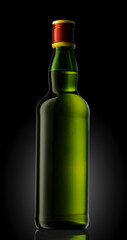 A bottle of whisky in green glass with a red cap on black background.