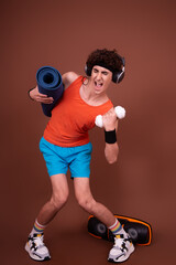Retro style. A young attractive guy is doing aerobics.