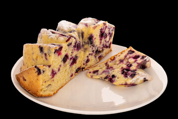 One vanilla cupcake with cherry on white ceramic plate, macro, isolated on black background.