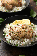 Grilled Chicken thighs served with rice in a black bowl