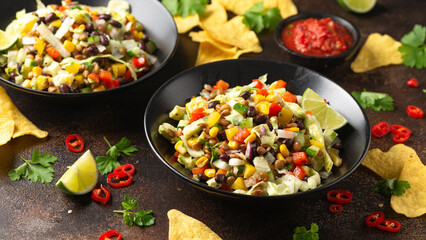 Mexican style salad of black beans, lentils, corn, tomato and lettuce with a salsa and tortilla chips