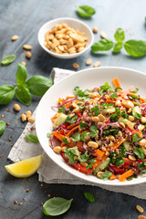 Asian Quinoa salad with fresh vegetables, peanuts and herbs. Healthy food.