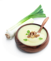 Homemade cream leek soup with fried bacon slices isolated on white