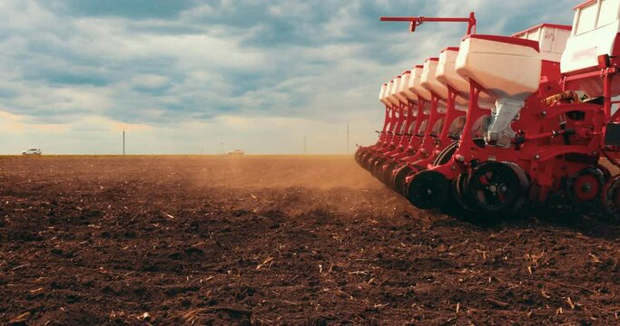 Agriculture. Tractor Seeder it Plants Seeds in the Ground in Field on the Farm. Slow motion. Tillage Equipment. 