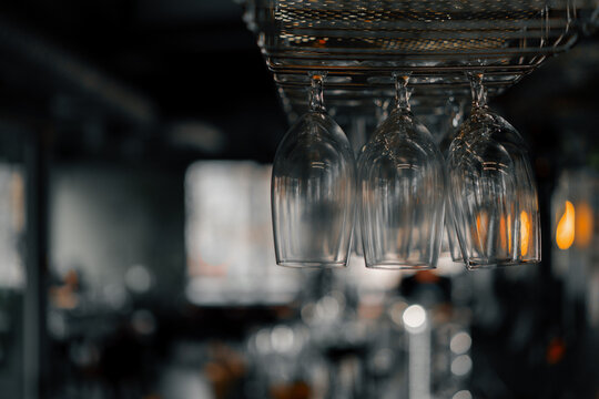 A lot of glasses hanging in bar Empty glassware in restaurant or cafe for beverage Alcoholic drinks