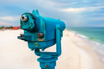 A light blue coin-operated telescope mounted on the Pensacola fishing pier