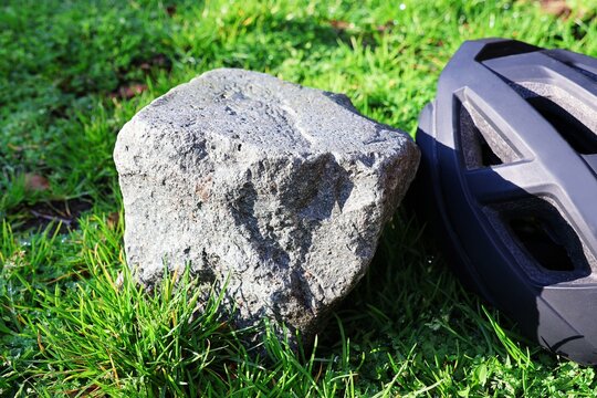 Cobblestone and bicycle helmet in close up. Concept Belgian cycling classic Paris-Roubaix.