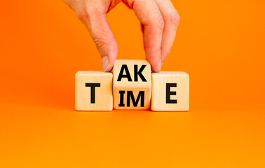 Take your time symbol. Concept word Take Time on wooden cubes. Beautiful orange table orange background. Businessman hand. Business and Take your time concept. Copy space.