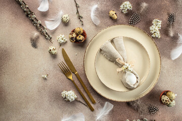 Table setting for celebrating easter. Easter egg in bunny napkin on plate. Happy Easter holiday concept. place for text, top view