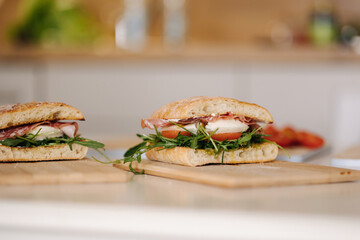 Two delicious Italian sandwich on wooden board. Healthy food concept