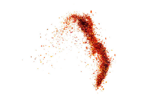 Isolated pepper splashes on a white background. Explosion. Chile. Paprika. Spice. Hot pepper powder. Taste of pepper. Mexican. Element for the design. Flying powder.