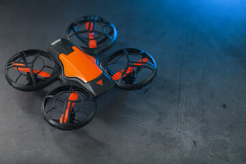 Gaming orange mini drone on a dark background