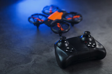 Naklejka premium Quadcopter drone with joystick control and blue neon backlight