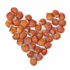 Healthy food, vegetarianism. dried hazelnuts laid out in a heart shape on a white background