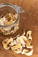 Porcini mushrooms cut into slices and dried are used to prepare vegetarian dishes. Dried Porcini Mushrooms On A Wooden Kitchen Table