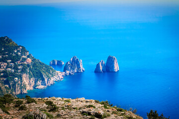 View from Monte Solaro of Faraglioni, towering rock formations out of the Tyrrhenian Sea, island of Capri, in Campania region, southern Italy.