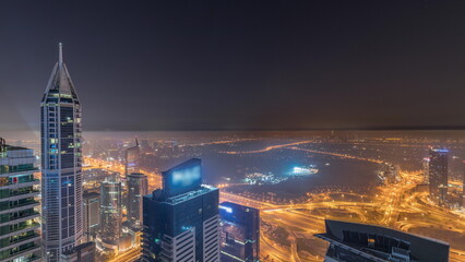 Aerial skyline with Golf Club, hotels and residential areas far away in desert in Dubai all night...