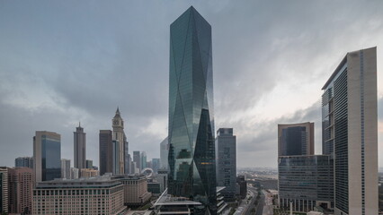 Dubai International Financial district aerial night to day timelapse. Panoramic view of business office towers.