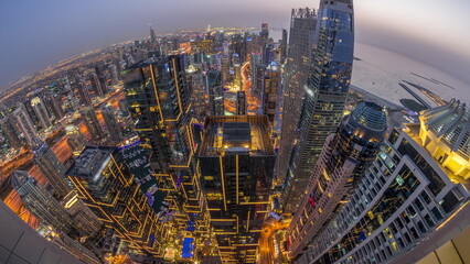 Skyline panorama of Dubai Marina showing canal surrounded by skyscrapers along shoreline day to...