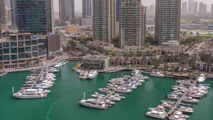 Fototapeta premium Luxury yacht bay in the city aerial timelapse in Dubai marina