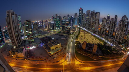 Fototapeta na wymiar Panoramic skyline of Bay Avenue with modern towers residential development in Business Bay aerial day to night timelapse, Dubai