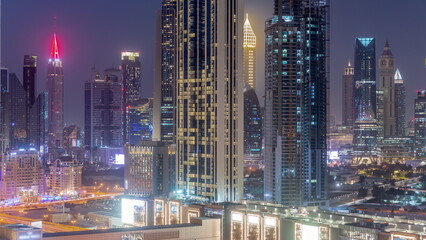 Naklejka na ściany i meble Row of the tall buildings around Sheikh Zayed Road and DIFC district aerial day to night timelapse in Dubai