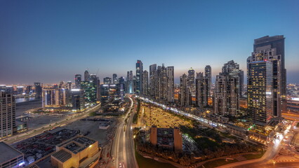Naklejka premium Panorama of Bay Avenue with modern towers residential development in Business Bay aerial day to night timelapse, Dubai