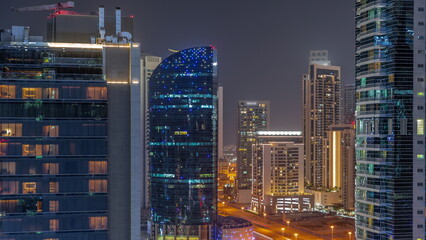 Cityscape of skyscrapers in Dubai Business Bay aerial night timelapse