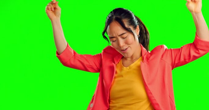 Woman, happy dance and freedom on green screen, background and studio for fun party celebration. Dancing, smile and asian model with excited energy to celebrate happiness, groovy music and winning